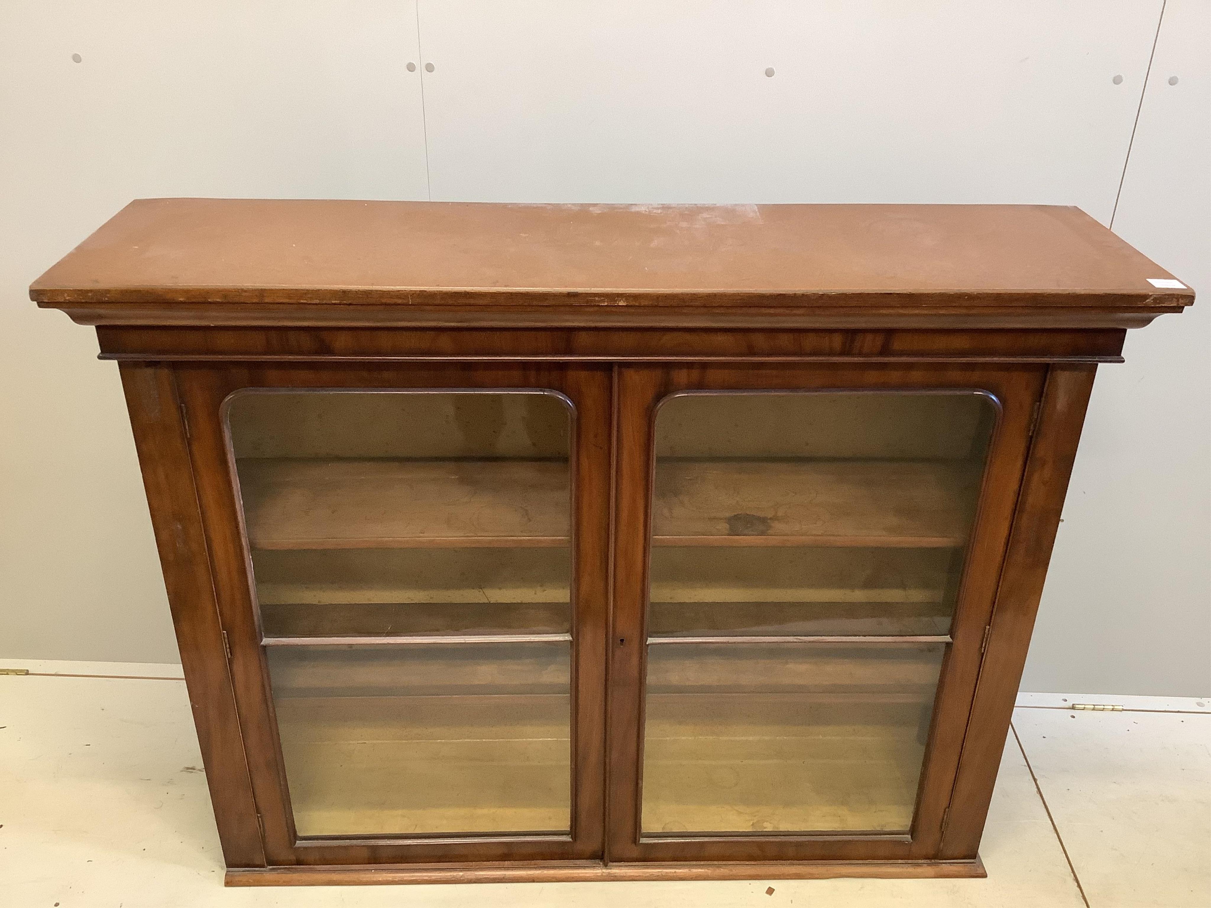 A Victorian mahogany bookcase, adapted, fitted with a pair of glazed doors, width 149cm, depth 38cm, height 116cm. Condition - fair